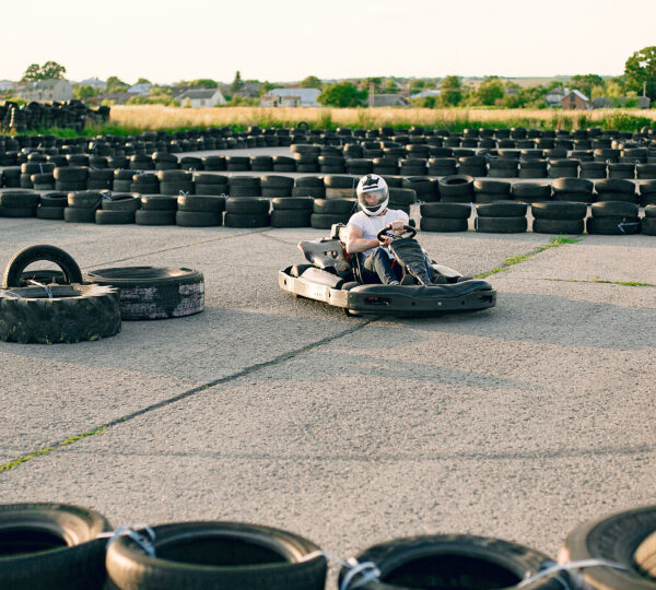 Karting. Man in a white t-shirt. Male with a kart car